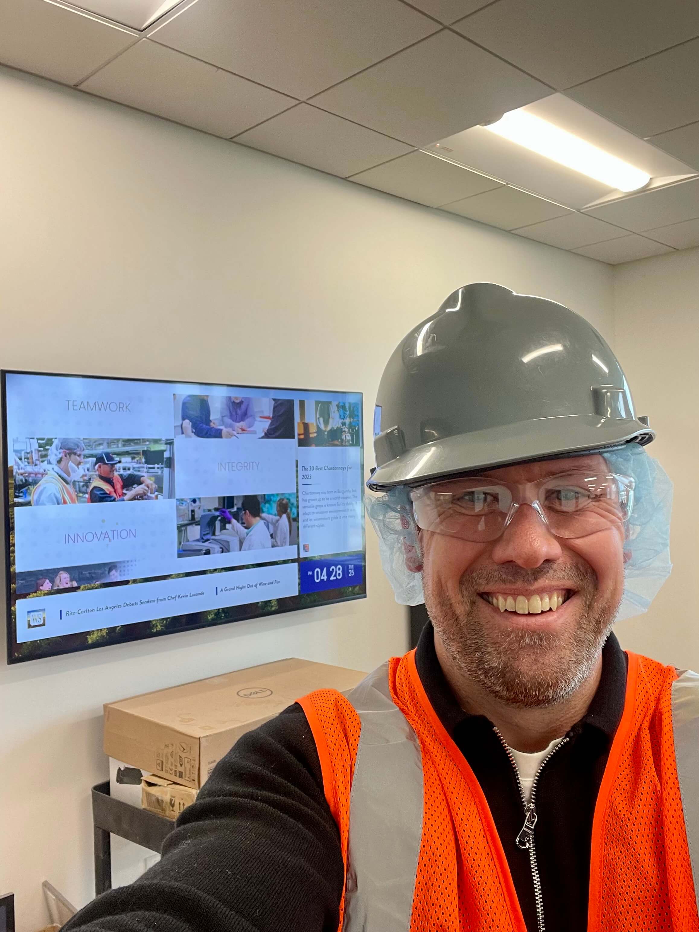 Professional construction or engineering site visit wearing safety equipment, demonstrating hands-on involvement in technical or industrial projects