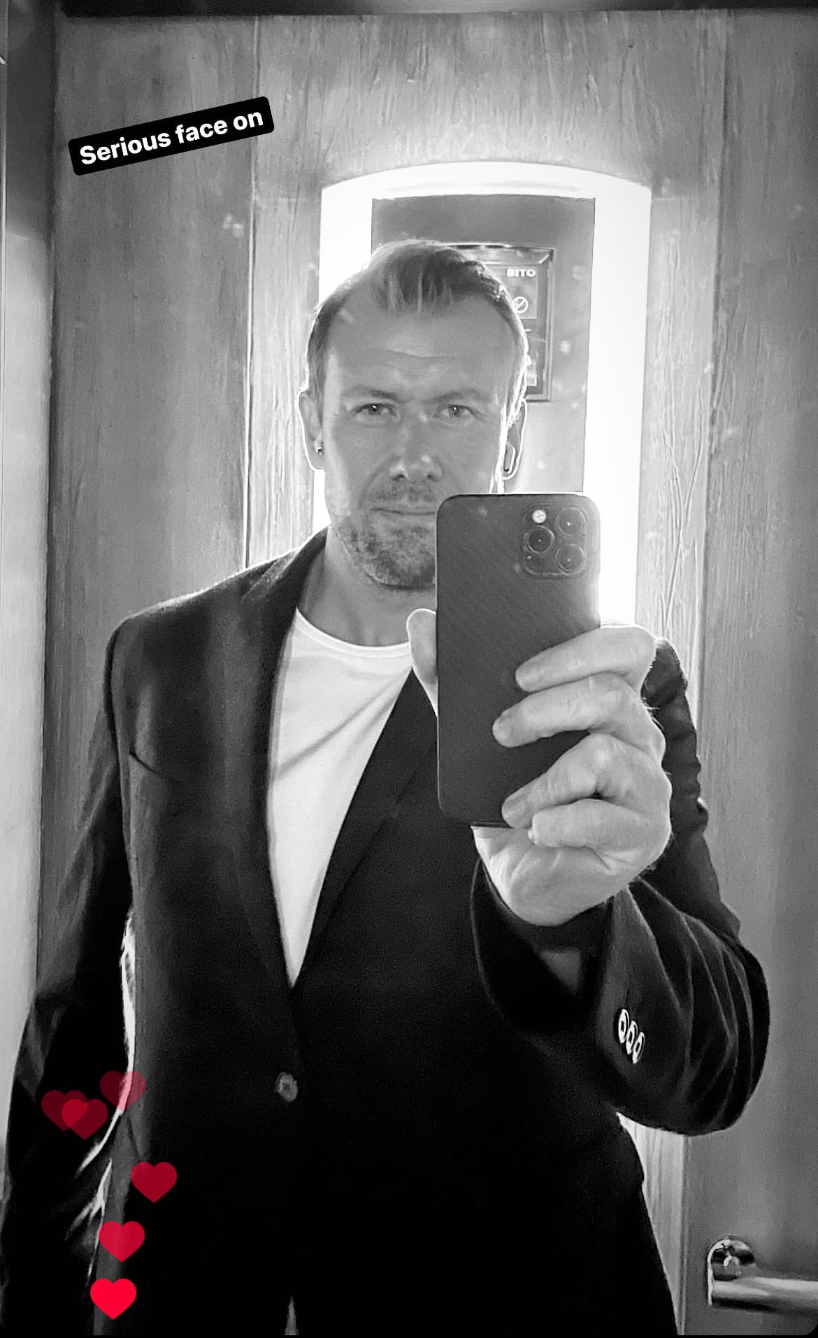 Contemplative self-portrait with a more serious expression, representing a moment of professional reflection or thoughtful introspection